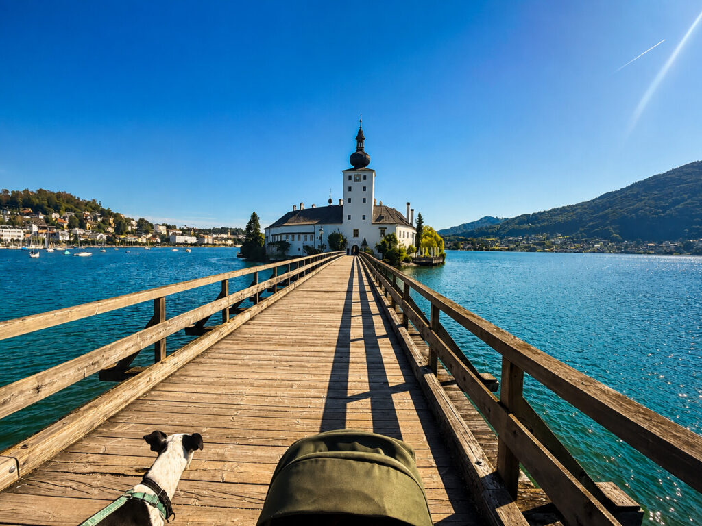 Holzbrücke zum Schloss Ort mit Hund und Kinderwagen im Vordergrund